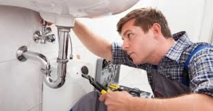 plumber working on sink